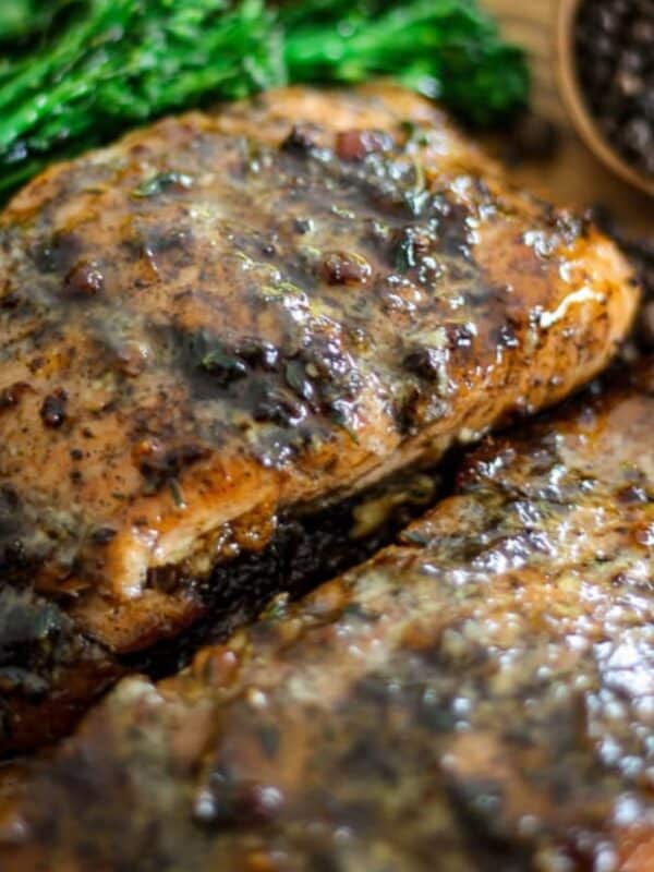 Close-up of glazed honey jerk salmon fillets beside broccolini.