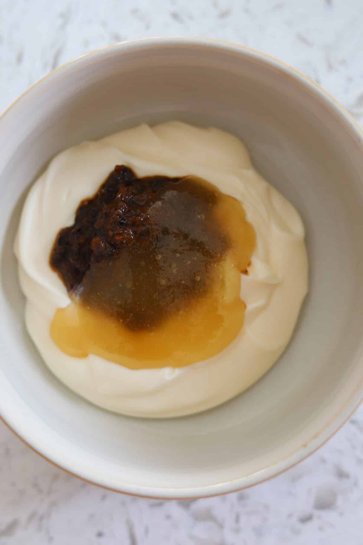 Bowl of mayonnaise with jerk marinade and honey added.