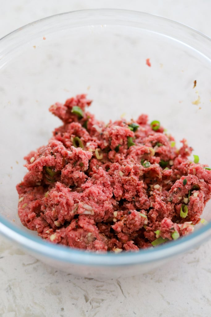 seasoned ground beef for jerk burgers in bowl.