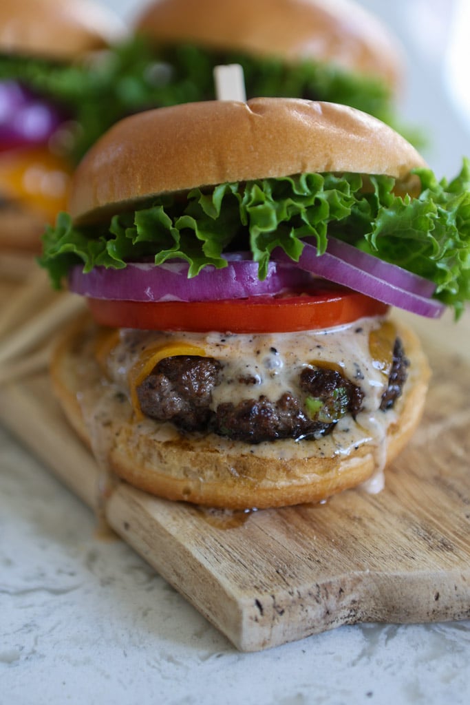 jamaican jerk burger with honey jerk mayo and burger toppings.